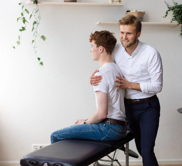 Chiropractor treating shoulder pain